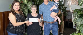 Super Dad Jason Teeter is presented his Gift Certificate from Chamber Director Tina 
Fernandez, left, and two free dinners from Lana Slocum and the Jet Drive-in, center.  Jason and his wife Jacque have three sons, Jacob, Jaxon and Jadon and happy little grandson Wesley Hayes Teeter pictured here with his proud grandfather.