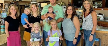 Super Dad Casey Settlemyer is pictured with his family as Leigh Angell to the left and Tasha Medina to the right, present him with his specially filled gift basket from Hugoton Drug. From left to right is the 
Settlemyer family - Cody with Beth, Rylee and Sadie, and Casey with Rigley. Tina 
Fernandez, the director of Hugoton 
Chamber is next to Casey. She presented Casey with the $50 Gift Certificate. 
The girls were the ones who signed their Super Dad up at all the businesses. 
Congratulations Casey!!