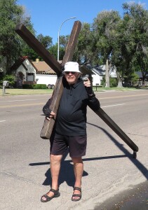 Kenn Neyland carries a rugged wooden cross on his shoulder for all who don’t have it in their lives. He has been dong it for eight years and is almost 85 years old! He asks for blessings for the towns he visits. He travels about 13 miles a day and has covered over half the state of Kansas from Wichita to Concordia and down over the south portion of the state. He visited Hugoton Thursday, walking up and down Main Street and was headed to Elkhart, Johnson and Ulysses after that. Then he will be back at home in Great Bend. He hands out bookmarks with the The Crossman’s Prayer printed on them and feels everyone should read it. It changed his life and he feels you can learn much from Jesus. He spent one whole year in Calforina and has traveled thousands of miles asking for blessings for the towns he visits. Some of the states he has carried it are Virginia, Georgia, Nebraska, Florida, New York, California, etc.