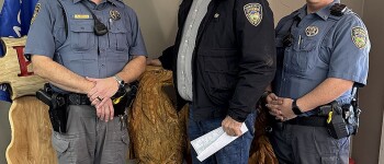 Wishing everyone a Safe and Merry Christmas and 
delivering the Sheriff’s report are, left to right, Undersheriff 
TJ Steers, Sheriff Ted Heaton and Deputy Cuylor Miller.