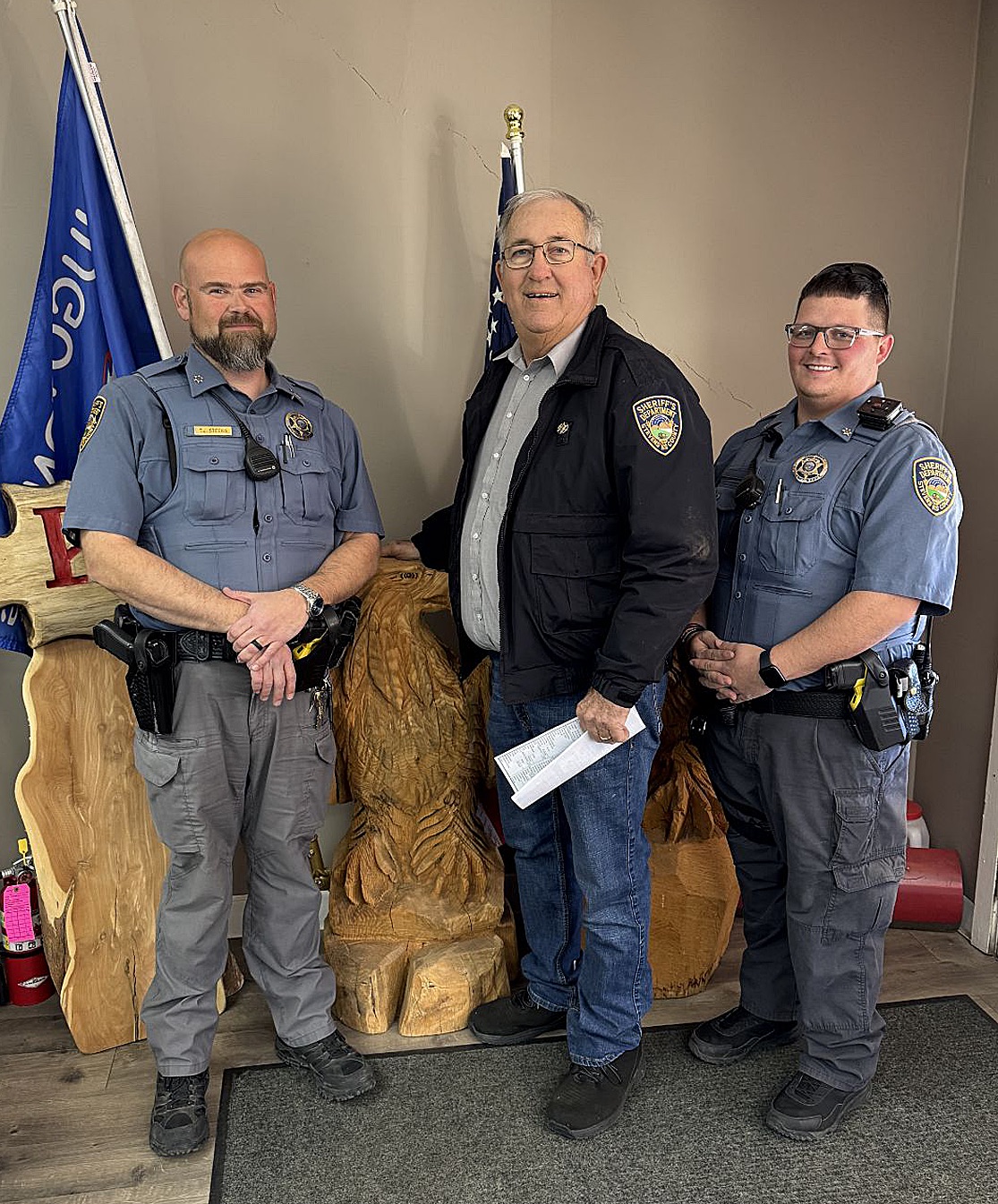 Wishing everyone a Safe and Merry Christmas and 
delivering the Sheriff’s report are, left to right, Undersheriff 
TJ Steers, Sheriff Ted Heaton and Deputy Cuylor Miller.