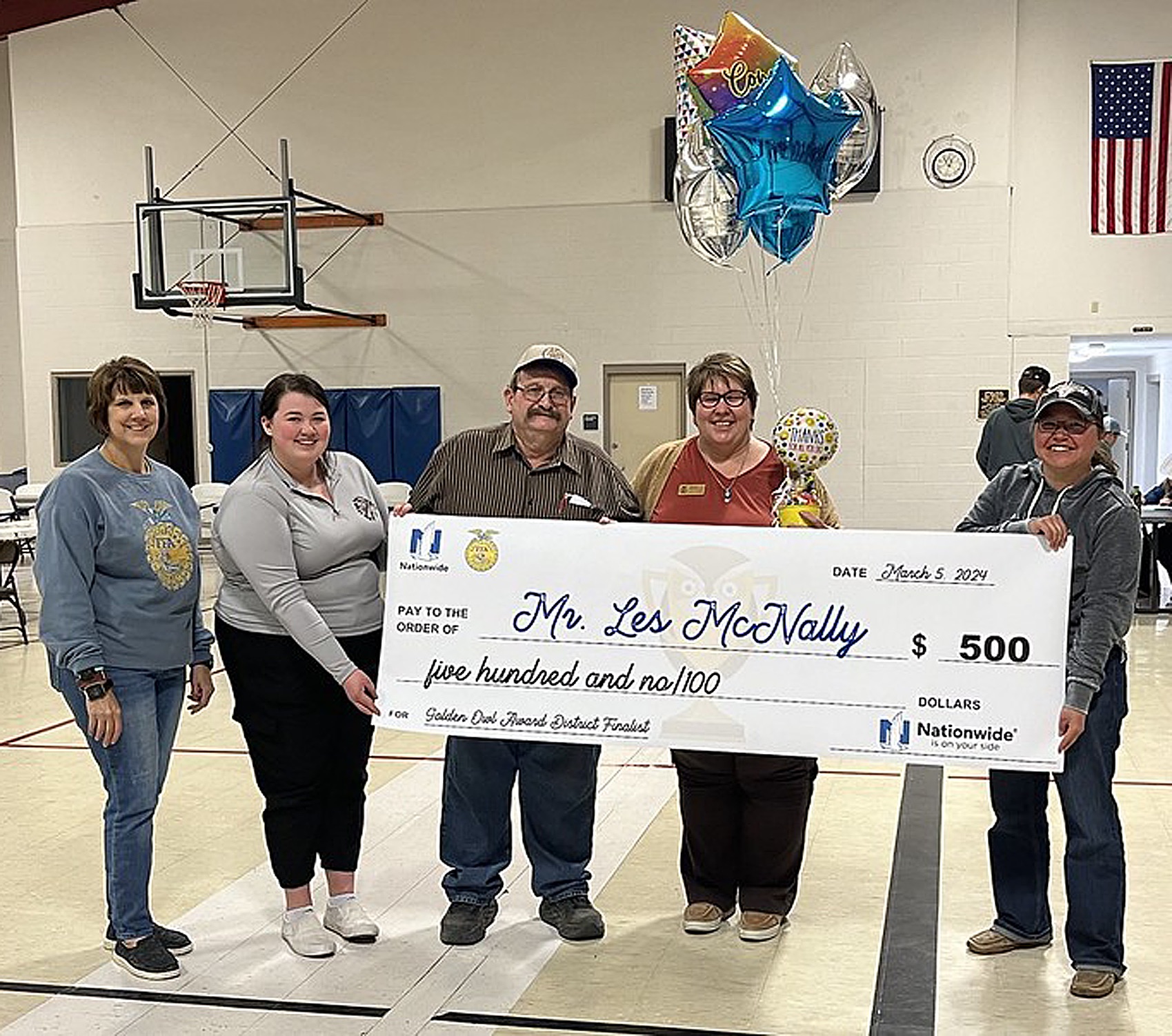 Mr. Les McNally is pictured above holding his check for $500. He also received an engraved plaque and is one of the Regional winners in the 2024 Kansas State Gold Owl Award. He 
received the check at the ninety-sixth Kansas FFA Convention.