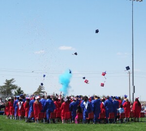 Hugoton High School and Learning Academy graduates celebrate and throw their hats into the air after graduation ceremony Saturday morning.